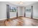 Bright bedroom featuring hardwood floors, a ceiling fan, and natural light from the windows at 1225 15Th St, Palm Harbor, FL 34683