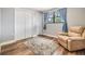 Bedroom with hardwood floor, closet, chair and large window at 1225 15Th St, Palm Harbor, FL 34683