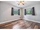 Cozy bedroom featuring wood-look floors, neutral walls and bright windows at 1225 15Th St, Palm Harbor, FL 34683