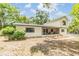 Attractive exterior view of the home, featuring well-maintained landscaping, a screened porch, and ample natural light at 1225 15Th St, Palm Harbor, FL 34683