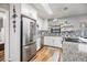 Contemporary kitchen featuring stainless steel appliances, granite countertops, and white cabinets at 1225 15Th St, Palm Harbor, FL 34683