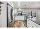 Bright kitchen featuring modern stainless steel appliances, granite countertops, and sleek white cabinetry at 1225 15Th St, Palm Harbor, FL 34683