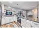Well-appointed kitchen with granite countertops, white cabinets, stainless steel appliances, and natural light at 1225 15Th St, Palm Harbor, FL 34683