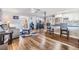 Open-concept living room with wood-style floors, access to the kitchen, and a comfortable seating arrangement at 1225 15Th St, Palm Harbor, FL 34683