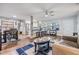 Bright, open-concept living space showcasing wood-style flooring, a breakfast bar, and a dining area at 1225 15Th St, Palm Harbor, FL 34683