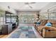 Comfortable living room featuring wood-style floors, abundant natural light, and a media center at 1225 15Th St, Palm Harbor, FL 34683