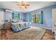 Bright, spacious main bedroom with wood-style floors, large windows, and a ceiling fan at 1225 15Th St, Palm Harbor, FL 34683