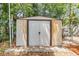 Durable metal shed in backyard providing extra storage space with double doors and secure latch at 1225 15Th St, Palm Harbor, FL 34683