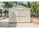 White wooden shed in the backyard, ideal for secure storage of outdoor tools and equipment at 1225 15Th St, Palm Harbor, FL 34683