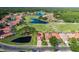 Beautiful aerial view of home, golf course, and ponds in a scenic residential neighborhood at 1228 Dartford Dr, Tarpon Springs, FL 34688