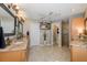 Well-lit bathroom with double sinks, granite countertops, cabinetry, a ceiling fan, and a walk-in shower at 1228 Dartford Dr, Tarpon Springs, FL 34688
