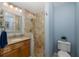 Updated bathroom with a tiled shower, granite vanity, and modern fixtures, offering a spa-like experience at 1228 Dartford Dr, Tarpon Springs, FL 34688