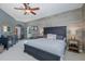 Spacious bedroom with wood accent wall, side tables with lamps, and dresser at 1228 Dartford Dr, Tarpon Springs, FL 34688