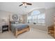 Cozy bedroom with a four-poster bed, neutral décor, and a large window, creating a serene and relaxing atmosphere at 1228 Dartford Dr, Tarpon Springs, FL 34688