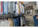 Organized walk-in closet featuring ample hanging space, shelving, vanity area, and stylish storage solutions at 1228 Dartford Dr, Tarpon Springs, FL 34688