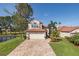 Charming home with a red tile roof, meticulously maintained lawn, and a brick driveway at 1228 Dartford Dr, Tarpon Springs, FL 34688