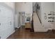 Bright foyer with hardwood floors, staircase, and decorative accents at 1228 Dartford Dr, Tarpon Springs, FL 34688