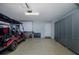 Spacious garage with a golf cart, bike, and custom gray cabinets for ample storage and organization at 1228 Dartford Dr, Tarpon Springs, FL 34688