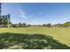 Scenic view of the expansive golf course in a peaceful residential neighborhood at 1228 Dartford Dr, Tarpon Springs, FL 34688