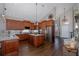 Open concept kitchen with granite counters, stainless steel appliances, and hardwood floors at 1228 Dartford Dr, Tarpon Springs, FL 34688