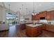 Open concept kitchen and living room with large windows and an eat-in kitchen island at 1228 Dartford Dr, Tarpon Springs, FL 34688