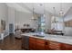 Bright, open-concept living space with an island kitchen, stainless appliances, and granite countertops at 1228 Dartford Dr, Tarpon Springs, FL 34688