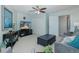 Cozy living room featuring neutral carpet, ceiling fan, and television sitting on a black media center at 1228 Dartford Dr, Tarpon Springs, FL 34688