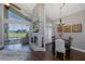 Bright living room featuring a stone fireplace, vaulted ceiling, dining area and expansive windows with a pool view at 1228 Dartford Dr, Tarpon Springs, FL 34688