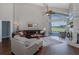 Spacious living room with a comfortable sectional sofa, vaulted ceilings, fireplace, and large windows overlooking the pool at 1228 Dartford Dr, Tarpon Springs, FL 34688