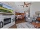 Open-concept living space with a fireplace, kitchen island with seating, and hardwood floors, perfect for entertaining at 1228 Dartford Dr, Tarpon Springs, FL 34688