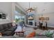Inviting living room featuring a fireplace, comfortable seating, vaulted ceilings, and access to a pool view at 1228 Dartford Dr, Tarpon Springs, FL 34688
