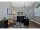 Spacious home office with dark wood floors, high ceilings, chandelier, and stylish decor at 1228 Dartford Dr, Tarpon Springs, FL 34688