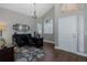 Home office with high ceilings, large windows, chandelier, and a modern black desk at 1228 Dartford Dr, Tarpon Springs, FL 34688