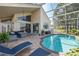 Outdoor living area with a screened lanai, comfortable seating and a private pool at 1228 Dartford Dr, Tarpon Springs, FL 34688