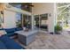 Comfortable outdoor seating on the lanai with view to the pool and back yard at 1228 Dartford Dr, Tarpon Springs, FL 34688