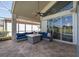 Comfortable screened patio with wicker seating, ceiling fan, and backyard pool views at 1228 Dartford Dr, Tarpon Springs, FL 34688