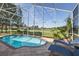 Sparkling private pool with screened enclosure overlooking the lush green golf course at 1228 Dartford Dr, Tarpon Springs, FL 34688