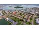 Aerial view features a residential community near the water, showcasing a shared pool and well-maintained surroundings at 12321 Sun Vista W Ct # 52, Treasure Island, FL 33706