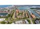 An aerial view showing a block of lovely condos with private yards, a pool, and manicured greenery in the community at 12321 Sun Vista W Ct # 52, Treasure Island, FL 33706