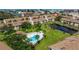 Scenic aerial shot capturing a community pool and grounds surrounded by well-kept condominium buildings at 12321 Sun Vista W Ct # 52, Treasure Island, FL 33706