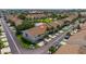 Aerial view of the townhome complex, featuring well-maintained landscaping, a pond, and a community pool at 12321 Sun Vista W Ct # 52, Treasure Island, FL 33706