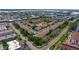 Aerial view of the townhome community, showcasing the layout with lush landscaping and a central pond at 12321 Sun Vista W Ct # 52, Treasure Island, FL 33706