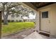 Backyard with a view of a lush green lawn, mature trees, and a glimpse of the surrounding community at 12321 Sun Vista W Ct # 52, Treasure Island, FL 33706
