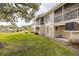 Backyard featuring a well-manicured lawn, screened patios, and access to the community pond at 12321 Sun Vista W Ct # 52, Treasure Island, FL 33706