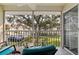 Relaxing screened balcony with chairs overlooking the well-maintained green space and mature trees at 12321 Sun Vista W Ct # 52, Treasure Island, FL 33706