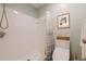 Cozy bathroom with a white-tiled shower, neutral shower curtain, and a modern toilet, exuding a fresh ambiance at 12321 Sun Vista W Ct # 52, Treasure Island, FL 33706