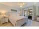 Bright bedroom features a ceiling fan, balcony access, and coastal decor at 12321 Sun Vista W Ct # 52, Treasure Island, FL 33706