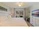 Comfortable bedroom with desk, TV, and sliding doors to screened lanai at 12321 Sun Vista W Ct # 52, Treasure Island, FL 33706