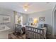 Bright bedroom featuring twin beds, a ceiling fan, neutral decor, and a sunlit window with decorative wall art at 12321 Sun Vista W Ct # 52, Treasure Island, FL 33706