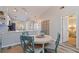 Dining room with a round wood table, four chairs and view of kitchen area at 12321 Sun Vista W Ct # 52, Treasure Island, FL 33706